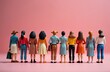 © Vadym - Small figures of women stand in line facing away from camera on pink background. Represents teamwork diversity equality and sisterhood. Group shows unity and female power.