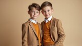 Two young boys in matching brown suits, orange sweaters stand together. Smile gently, looking forward. Stylish haircuts frame youthful faces. Charming portrait sibling camaraderie.