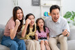 © Kawee - Asian happy family enjoying games with their little girl daughter.
