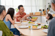 © Kawee - Asian loving family spending quality time, having dinner in cozy house.