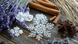 Delicate lace snowflakes lying on a table beside dried lavender and cinnamon bundles. .