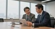 © junet - Business Meeting Two Asian Men Reviewing Data on Tablet laptop