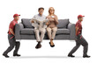 © Ljupco Smokovski - Mature couple sitting on a sofa carried by movers