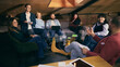 © master1305 - Startup team discussion in modern coworking lounge area. Concept of informal team meetings, modern workspace communication, collaborative decision making in startup environment.