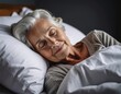 © Ant - A serene elderly woman peacefully sleeping in a cozy bed, enveloped by soft pillows, radiating calmness and comfort.