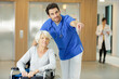 © auremar - male nurse looking at senior woman in wheelchair