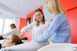 © auremar - teacher helping student to become hairdresser