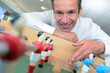 © auremar - man presenting table football game