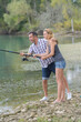 © auremar - happy couple fishing by the pond
