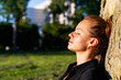 © Barillo_Images - City life balance concept with woman resting near tree outdoors