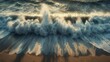 © Intie - Aerial view of a crashing wave on a sandy beach, sunlight illuminating the water