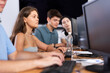 © JackF - Concentrated young girl studying in computer lab with fellow students engrossed in coursework..