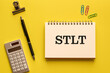 © hogehoge511 - There is notebook with the word STLT. It is an abbreviation for Singapore Treaty on the Law of Trademarks as eye-catching image.