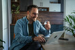 © Miljan Živković - Happy man shopping online using laptop and credit card
