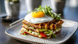 © mureed - Stacked waffles with fried egg and fresh herbs on white plate
