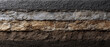 © Mind - Asphalt crushed stone gravel sand soil layered cross section, gritty texture, earthy tone