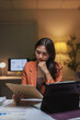 © Phimwilai - Young woman analyzing data working late night