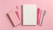 © Hanna - Bright pink workspace with notebooks and pens arranged neatly on a clean surface for study and writing tasks