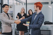 © ARMMY PICCA - Meeting, partnership and business people shaking hands in the office for a deal, collaboration or onboarding. Diversity, professional and employees with handshake for agreement, welcome or greeting.