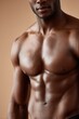 © Nang - A close-up of an African man's muscular chest and abs, dark glowing skin, soft side lighting highlighting contours
