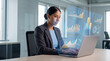 © Rendara Studio - Female analyst reviewing business data visualizations on laptop screen