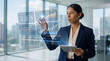 © Rendara Studio - Woman reviewing investment data on a transparent financial dashboard