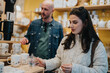 © qunica.com - A woman selects a teapot as a man looks on in a bright ceramic shop. The scene captures a casual shopping moment for home ware and gifts.