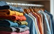 © Liam - Stack of second hand clothes with used wardrobe for reuse and empty craft card. Circular fashion, fast fashion, Sustainable ethical consumption and shopping, donation, thrifting shop concept