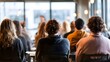 © kirania - Audience attending a presentation or seminar in a modern conference room.