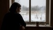 © D.bongStudio - A solitary woman, silhouetted against a frosty windowpane, finds a moment of quiet reflection amidst the cold embrace of winter, contemplating the view outside