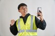 © yashis007 - Excited Construction Worker Taking Selfie with Smartphone