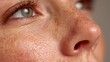 © horizon - Extreme macro shot reveals clean human skin texture on a cheek, highlighting visible pores and fine hairs under soft natural lighting.