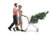© Ljupco Smokovski - Profile shot of a young couple walking and pushing a christmas tree in a shopping cart