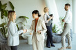 © BGStock72 - Two businesswomen shake hands warmly in a modern office setting