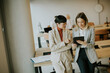 © BGStock72 - Two women discuss a project in a modern office setting during work hours