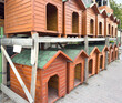 © ADDICTIVE STOCK - Wooden dog kennels stacked in an outdoor setting