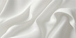 © FSompa - Elegant white silk and satin fabric background featuring smooth luxury waves and soft rippled textures for a shiny fashion drapery backdrop