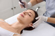 © New Africa - Woman undergoing microneedling procedure in beauty salon, closeup