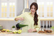 © New Africa - Smiling woman pouring delicious smoothie from blender into glass at white marble table in kitchen