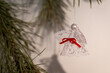© lapis2380 - Starched knitted angel with a white pearl instead of a head hanging on a Christmas tree.