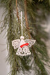 © lapis2380 - Starched knitted angel with a white pearl instead of a head hanging on a Christmas tree.