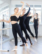 © JackF - Female ballet dancers doing various ballet movements at a ballet barre in fifth position