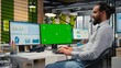 © DC Studio - Business manager working on report writing next to chroma key screen, reviewing data analytics in the office. Specialist building a business strategy with vision, planning progress.