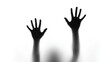 © hamid - Silhouetted hands raised against a white background with a blurred figure