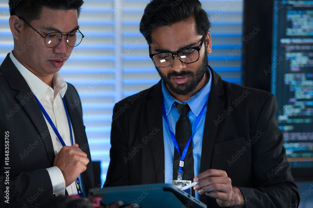 Lead developers analyze system architecture late night using tablet ...