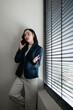 © Tj - Asian businesswoman communicating on mobile phone in office