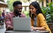 © Chloe - Coworking and freelance concept.Mixed race, middle age black skin man and woman working together on laptop computer while sitting on cafe terrace. High quality