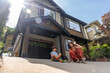 © unai - Happy family playing together outside their house on a sunny summer day