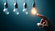 © utaem2022 - Hand touching glowing light bulb finding inspiration solution