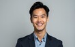 © na - Portrait of a smiling young asian business man, isolated on gray background. High quality
